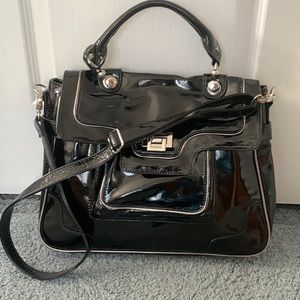 Black patent leather shoulder bag with handle & shoulder strap & pockets.